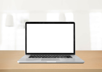 Laptop with blank screen on table. white room background