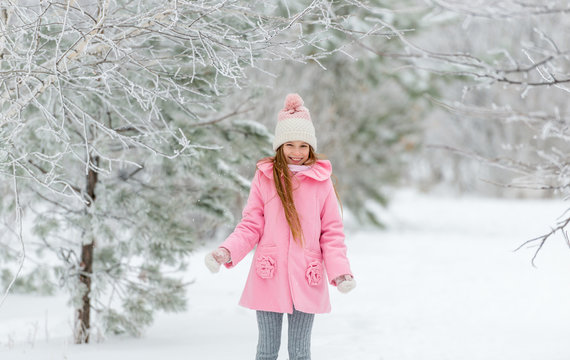 Girl in pink coat enjoying being outside