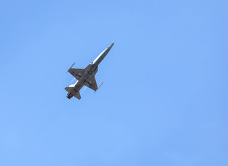 Fototapeta na wymiar military fighter jet aircraft flying blue sky background