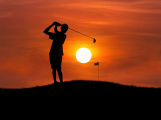 silhouette golfer hit golf ball toward the hole at sunset