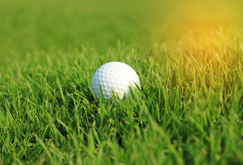 Golf ball in rough grass on fairway  