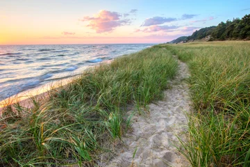 Photo sur Plexiglas Amérique centrale A Walk On The Beach. Sandy trail winds along a Great Lakes beach with a sunset horizon and sand dunes as a backdrop. Muskegon, Michigan.