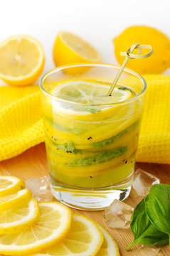 Glass of fresh lemon drink with basil