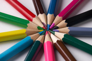 Fototapeta premium Circle of colorful pencils on white background. Close up shot