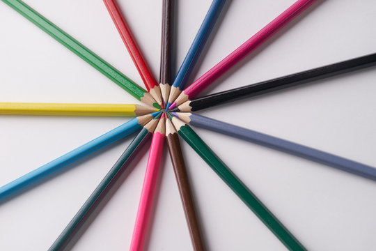 Circle of colorful pencils on white background. Close up shot