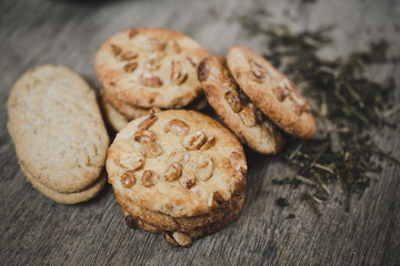 Stack of cookies with peanuts close-up on old wooden table