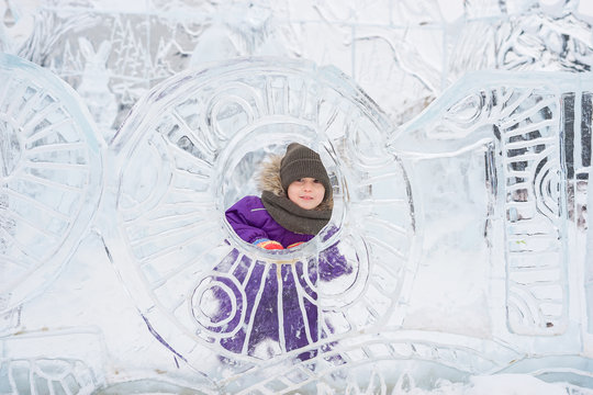 Boy hiding behind an ice sculpture