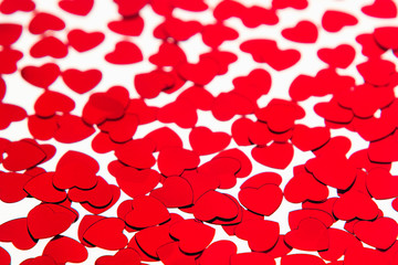 Valentines day pattern of red hearts confetti on white background. Festive Valentine.