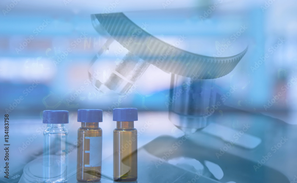 Wall mural compond microscope and syringe in scientist hand in science labb