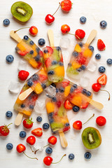 Homemade popsicles with berries and fruits.