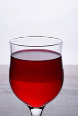 glass of red wine .glass of wine on a light wooden background