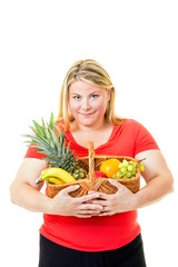 Overweight young woman with basket of fresh fruit.