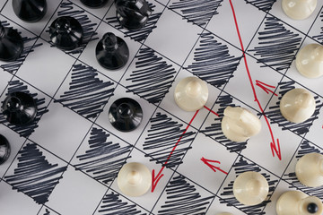 White strategy board with chess figures on it. Plan of battle. Close up, Top view