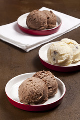 Chocolate and vanilla ice cream bowls are  in the dishes.