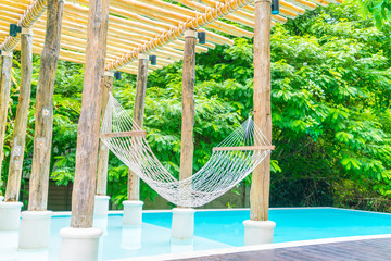 White hammocks in Luxury swimming pool .