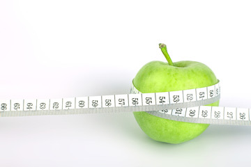 green apple with Measuring tape on white background in concept o