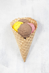 Various ice cream scoops in the cone.