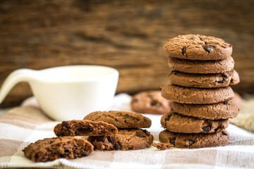 Close up stacked chocolate chip cookies on  napkin 