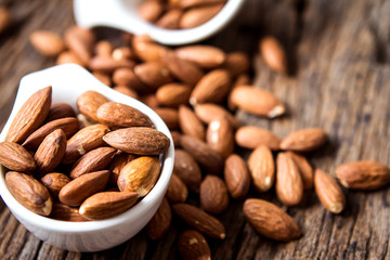 close up Peeled almonds nut  in small white cup 