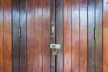 Fototapeta premium Old locked wooden doors in abandoned wooden house with padlocks