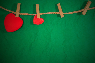 Red heart on green background, Valentine day idea.