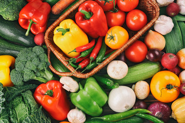 Fototapeta na wymiar Wicker basket with fresh vegetables on background