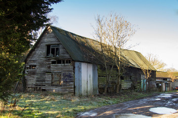 Old derelict empty wooden barn in country