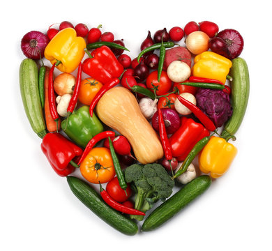 Heart made of fresh vegetables on white background