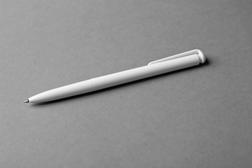 Blank ballpoint pen on grey background