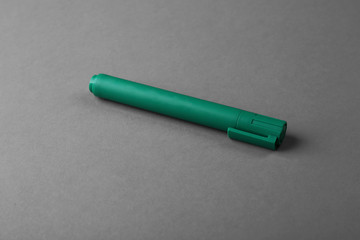 Green felt pen on grey background