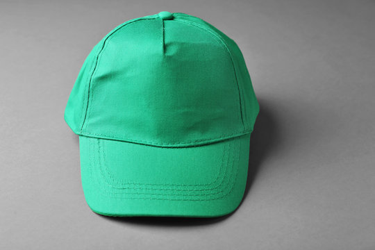 Blank green baseball cap on grey background