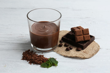 Chocolate mousse in glass on wooden background