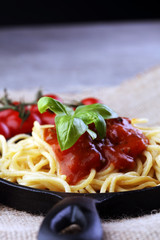 Plate of delicious spaghetti Bolognaise or Bolognese with savory minced beef and tomato sauce garnished with parmesan cheese and basil