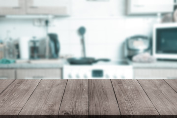 View from dark wooden table on a blurred kitchen interior. Toned