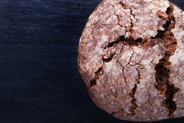 Homemade chocolate cookies, shortbread on a black slate table