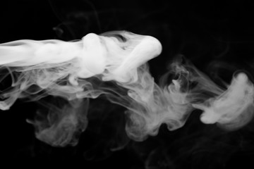 Cloud of smoke on black background. Selective focus