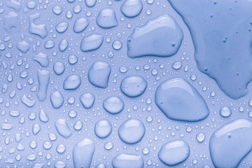Drops of water on a color background. Blue. Toned