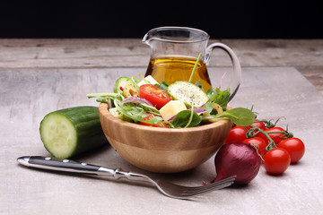 Caprese. Caprese salad. Italian salad. Mediterranean salad. Italian cuisine. Mediterranean cuisine. Tomato mozzarella basil leaves black olives and olive oil on wooden table. Recipe - Ingredients