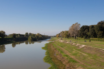 Fototapeta premium Arno river embankment in a sunny day. Florence. Italy.