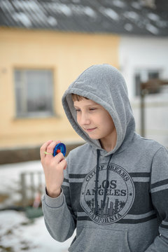 boy the teenager plays with the yo-yo on the street