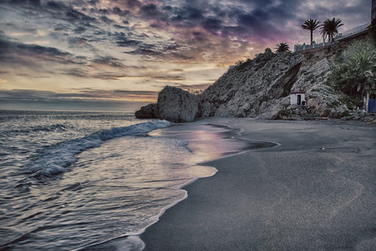 Carabeo beach at sunset with fishing hut, Nerja, Spain