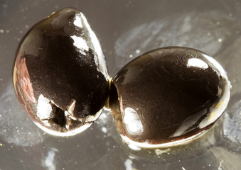 Ripe black olives on a black background