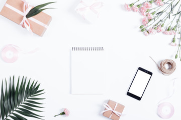 Festive arrangement: boxes with gifts, ribbons, notebook, mobile
