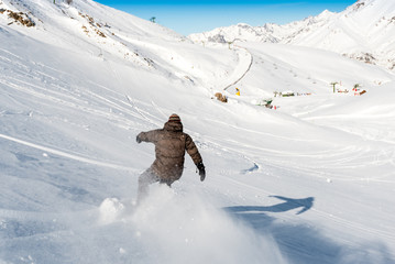 PANTICOSA, SPAIN - JUNE 19, 2017: a snowboarder goes downhill off-piste skiing
