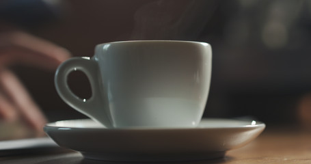 steam rising from espresso cup with fresh hot coffee shallow focus, 4k photo