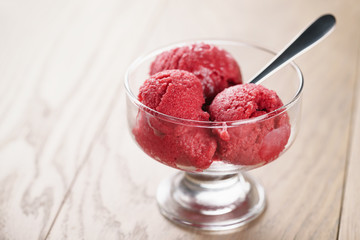 raspberry sorbet ice cream balls on wooden table, shallow focus - obrazy, fototapety, plakaty