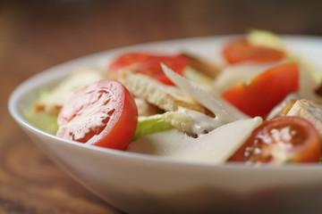 closeup photo of fresh made caesar salad with cherry tomatoes, shallow depth of field