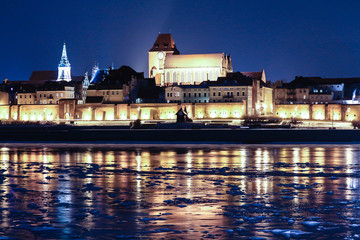 Torun Old Town night panorama view from across the frozen Vistula River