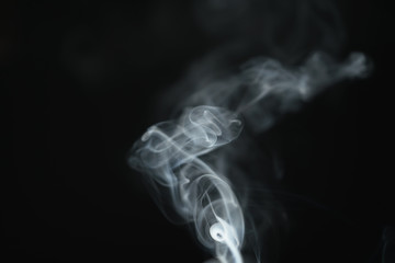 mystery light blue smoke over dark background with copy space, abstract photo