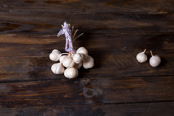 Fototapeta na wymiar Bunch of garlic on wooden background